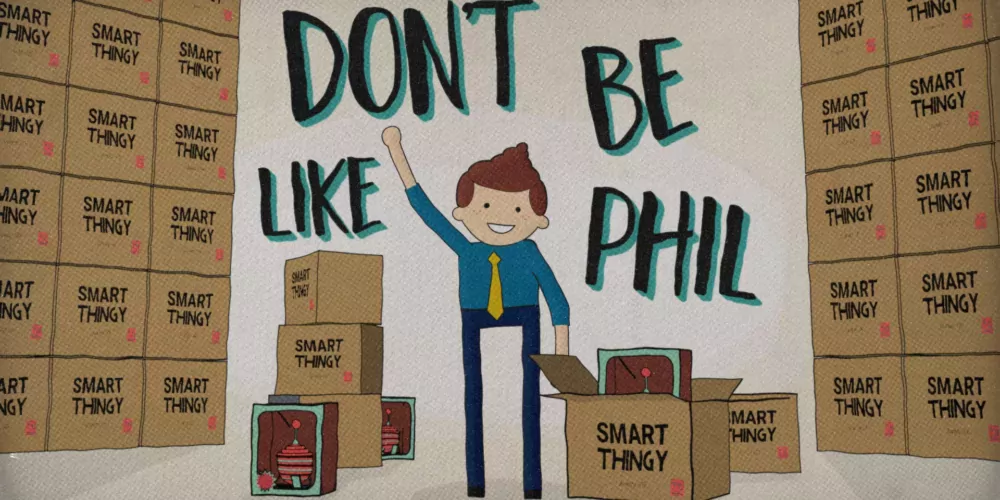 Phil waves at the viewer in front of piles of boxes of a weird product he sells.