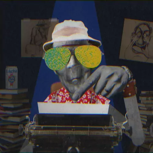 Hunter S Thompson types on his typewriter with piles of books and artwork in the background.